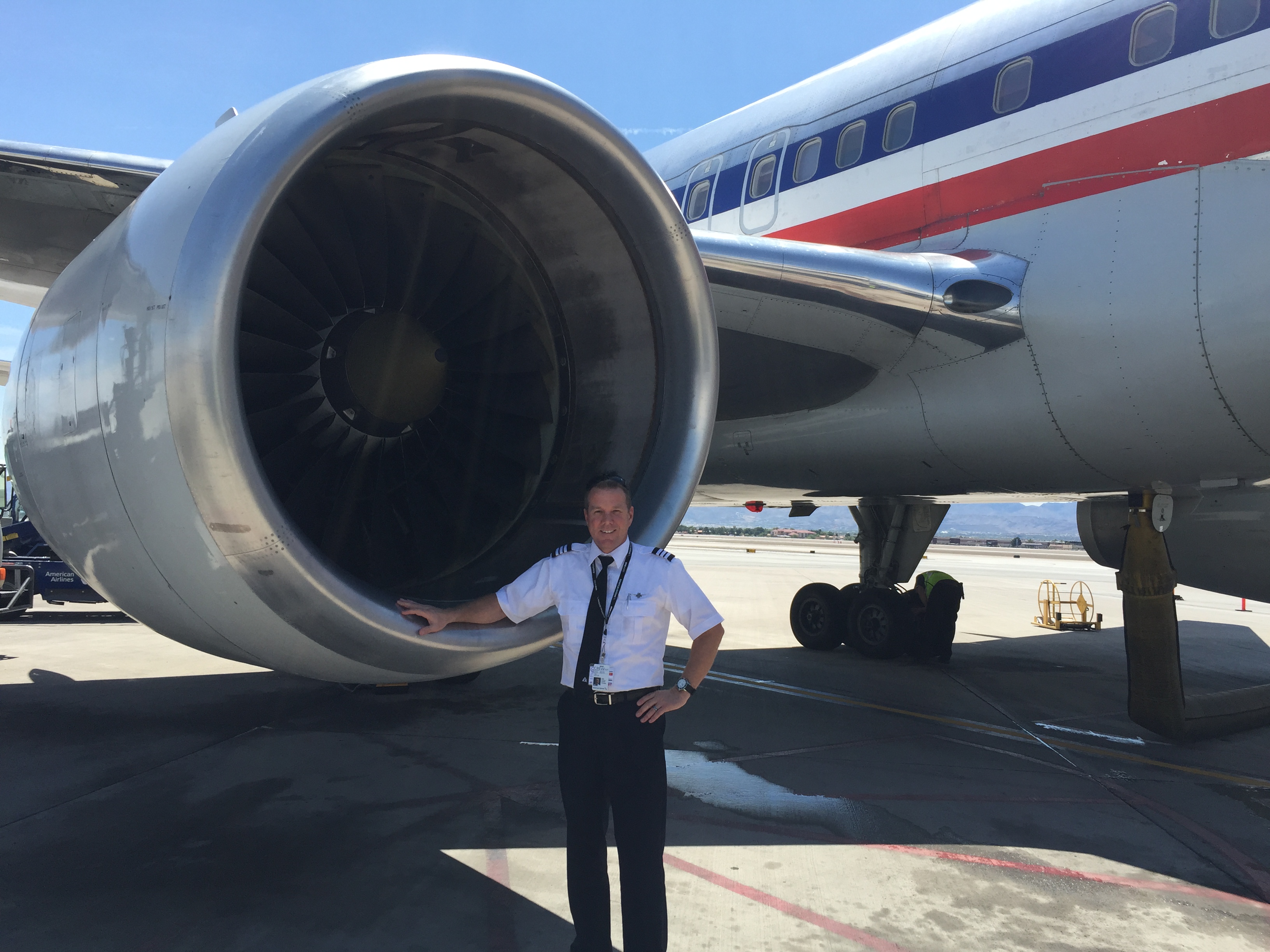 Troy beside a commercial aircraft