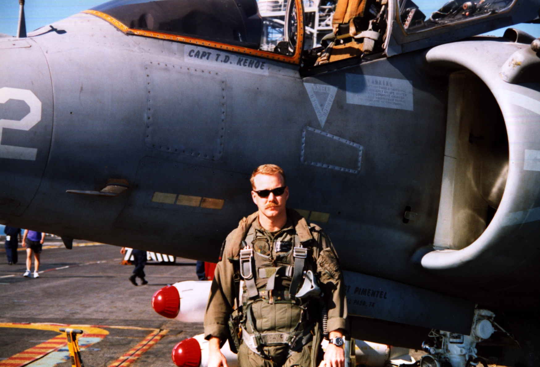 Troy beside a military aircraft