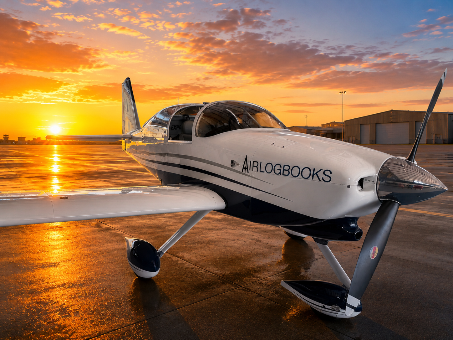Aircraft records spread across a wing with AirLogbooks open on a laptop.